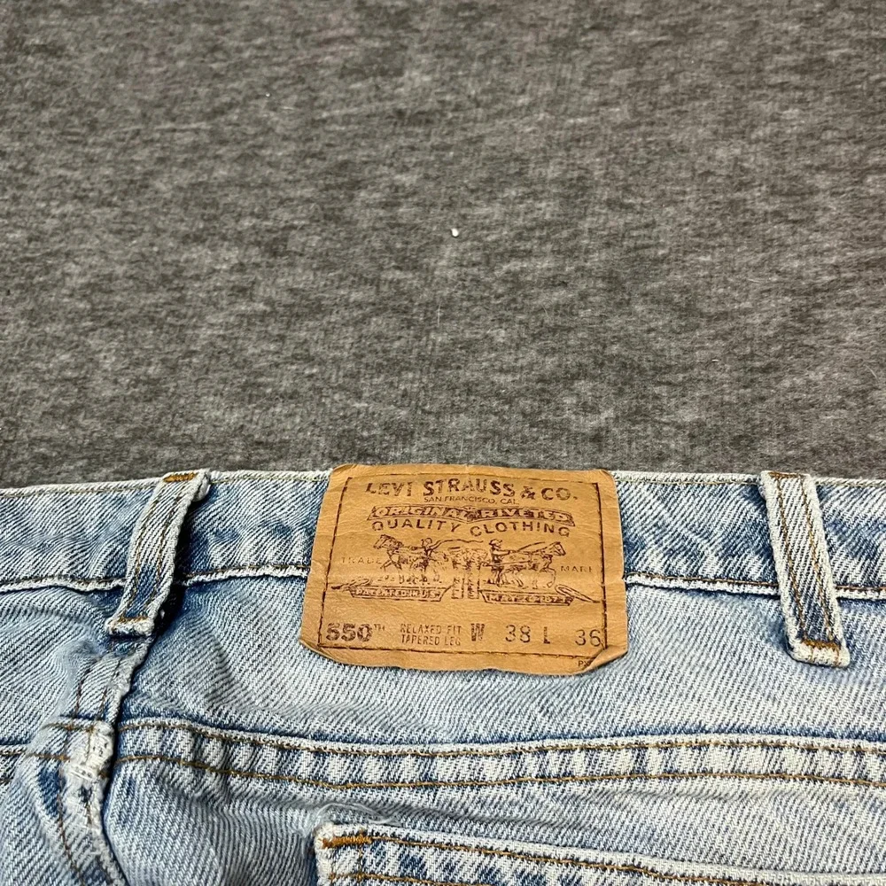 Vintage Levis 550 Made in USA Orange Tab Jeans 38x36 Light Wash 90s Tapered Leg
